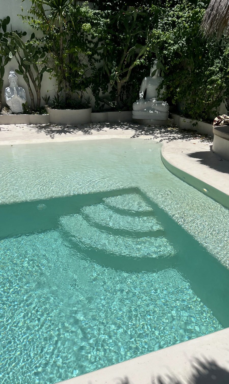 A villa swimming pool finished in Microcement Pool, with a continuous surface into the water.